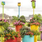 Colorful pollinator planter filled with lantana, salvia, and petunias attracting butterflies and bees on a sunny patio in Cincinnati, Ohio